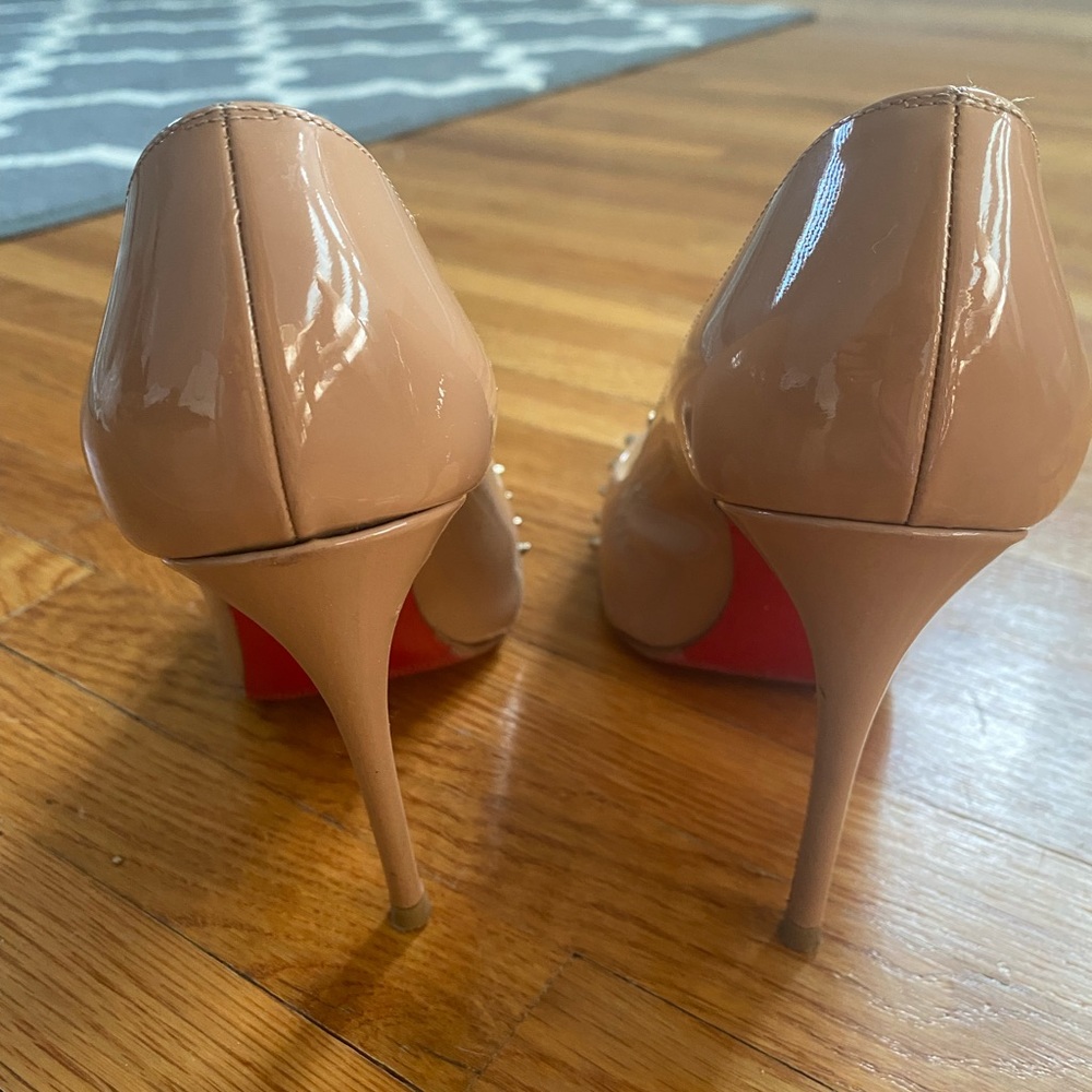 Nude Louboutin heels with gold spikes
